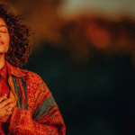 Person standing in warm golden light, grounded posture, symbolizing clarity, confidence, and personal reclamation.